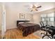 Bright bedroom with hardwood floors, large closet, and access to patio at 4980 E Donald Ave # 14, Denver, CO 80222