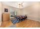 Bright bedroom with wood floors and access to a sunroom at 4980 E Donald Ave # 14, Denver, CO 80222