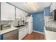 Kitchen with blue walls, tile backsplash, and modern appliances at 4980 E Donald Ave # 14, Denver, CO 80222