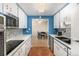 Kitchen with view to dining area, blue walls, and tile flooring at 4980 E Donald Ave # 14, Denver, CO 80222