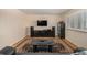 Bright living room with hardwood floors and home entertainment center at 4980 E Donald Ave # 14, Denver, CO 80222