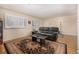 Living room with hardwood floors, black leather couch, and area rug at 4980 E Donald Ave # 14, Denver, CO 80222