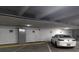 Image of a well-lit parking garage with numbered parking spots and a white car parked in one of the spaces at 4980 E Donald Ave # 14, Denver, CO 80222