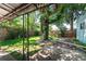 Charming backyard featuring a mature tree, a cozy covered patio, and a well-maintained lawn at 2205 S King St, Denver, CO 80219