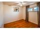 Simple bedroom with hardwood floors, a window with curtains, and a mirror at 2205 S King St, Denver, CO 80219