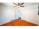 Empty bedroom with hardwood floors, ceiling fan, and closet with open door at 2205 S King St, Denver, CO 80219
