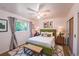 Well-lit bedroom with large window, closet, and hardwood floors at 2205 S King St, Denver, CO 80219