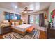 Bright bedroom features hardwood floors, a ceiling fan, and a large window for ample natural light at 2205 S King St, Denver, CO 80219