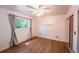 Bedroom with ceiling fan, vinyl wood flooring, and large window at 2205 S King St, Denver, CO 80219