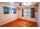 Empty bedroom with hardwood floors, ceiling fan, and window with natural light at 2205 S King St, Denver, CO 80219