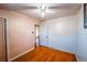 Small bedroom with wood floors and view into a connecting room at 2205 S King St, Denver, CO 80219