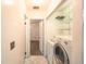 Functional laundry room with tile floor and open shelving at 2205 S King St, Denver, CO 80219