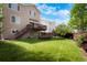 Spacious backyard with lush green grass, deck, patio, and fire pit at 737 Novick Ct, Castle Rock, CO 80109