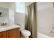 Well-maintained bathroom featuring a tub-shower combo, window, and a wood vanity at 737 Novick Ct, Castle Rock, CO 80109