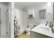 Well-lit bathroom with shower-tub combo, floral curtain, white vanity and tan tile floor at 737 Novick Ct, Castle Rock, CO 80109