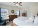 Bright bedroom with ceiling fan, neutral walls, and a large window with neighborhood views at 737 Novick Ct, Castle Rock, CO 80109