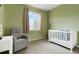 Charming Bedroom with a window, comfortable chair, crib and light green walls at 737 Novick Ct, Castle Rock, CO 80109