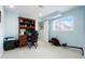 Home office featuring built-in bookshelves, neutral walls, and a bright window at 737 Novick Ct, Castle Rock, CO 80109