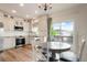 Modern kitchen featuring white cabinetry, stainless steel appliances, and a dining area with scenic views at 737 Novick Ct, Castle Rock, CO 80109