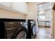 Convenient laundry room with modern washer and dryer units, storage cabinets, and easy access to the kitchen at 737 Novick Ct, Castle Rock, CO 80109