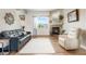 Comfortable living room showcasing hardwood floors, a cozy fireplace, and large windows at 737 Novick Ct, Castle Rock, CO 80109
