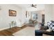 Open-concept living room with hardwood floors, seamlessly connecting dining and living areas at 737 Novick Ct, Castle Rock, CO 80109