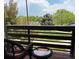 Relaxing balcony featuring a bistro set with views of green trees and distant landscaping at 539 Wright St # 203, Lakewood, CO 80228