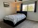 Cozy bedroom with patterned bedding, a ceiling fan, and a window with natural light at 539 Wright St # 203, Lakewood, CO 80228