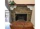 Charming fireplace with stone surround and wood mantel, perfect for cozy evenings at 539 Wright St # 203, Lakewood, CO 80228