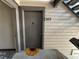 Entrance to unit 203 featuring a grey door and a charming sunflower door mat at 539 Wright St # 203, Lakewood, CO 80228