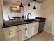 Updated kitchen featuring a black countertop, white cabinets, and stainless steel appliances at 539 Wright St # 203, Lakewood, CO 80228