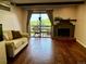 Comfortable living room boasting hardwood floors, a brick fireplace, and access to a balcony at 539 Wright St # 203, Lakewood, CO 80228