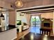 Bright living room featuring hardwood floors, fireplace, modern lighting, and a sliding glass door to the balcony at 539 Wright St # 203, Lakewood, CO 80228
