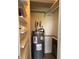 Water heater inside of utility closet with storage shelving at 539 Wright St # 203, Lakewood, CO 80228