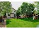 Backyard featuring a well-maintained lawn, mature trees and a play set at 7245 Prairie Cir, Longmont, CO 80504