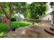 Spacious backyard featuring a patio area, privacy fence, and mature trees at 7245 Prairie Cir, Longmont, CO 80504