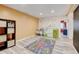Finished basement with a colorful accent wall, an overhead light, and durable wood-style laminate flooring at 7245 Prairie Cir, Longmont, CO 80504