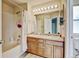 Bathroom features a double vanity, shower-tub combo with a shower curtain, and decorative tile flooring at 7245 Prairie Cir, Longmont, CO 80504