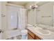 Cozy bathroom with a shower-tub combo, ample lighting and a modern vanity at 7245 Prairie Cir, Longmont, CO 80504
