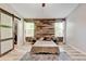 Bedroom features a rustic wood accent wall, soft natural light, and a neutral color palette throughout at 7245 Prairie Cir, Longmont, CO 80504