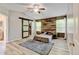 Bedroom features a rustic wood accent wall, a sliding barn door for the closet, and a neutral color palette at 7245 Prairie Cir, Longmont, CO 80504