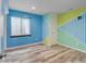Bright bedroom features unique wall design and wood-look flooring, creating a vibrant and modern space at 7245 Prairie Cir, Longmont, CO 80504