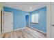 Bright bedroom features wood-look flooring and a window, offering natural light at 7245 Prairie Cir, Longmont, CO 80504