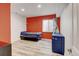 Bedroom boasts bright accent walls, wood-look floors, and a window, providing a cozy atmosphere at 7245 Prairie Cir, Longmont, CO 80504