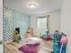 bedroom featuring colorful accent wall and whimsical decor, with durable wood-style laminate flooring at 7245 Prairie Cir, Longmont, CO 80504