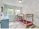 bedroom featuring a unique bunk bed, whimsical floral wallpaper, and bright natural light at 7245 Prairie Cir, Longmont, CO 80504