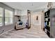 Versatile bonus room with wood-look floors and stylish furniture providing flexible space at 7245 Prairie Cir, Longmont, CO 80504