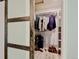 Bedroom closet featuring open shelves and racks for optimal storage and a decorative sliding door at 7245 Prairie Cir, Longmont, CO 80504