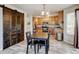 Cozy kitchen featuring wood cabinets, modern appliances, dining table, and sliding barn door at 7245 Prairie Cir, Longmont, CO 80504
