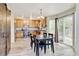 Warm kitchen featuring wood cabinets, modern appliances, dining table, and access to the backyard at 7245 Prairie Cir, Longmont, CO 80504
